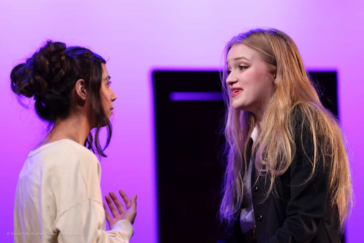 actors seem upset, they are arguing, light purple cyc light.